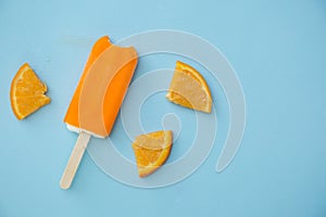 Popsicle with fresh orange on a table