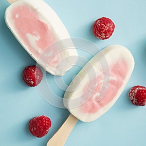 Popsicle with fresh raspberry on a table