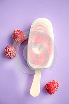 Popsicle with fresh raspberry on a table
