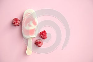 Popsicle with fresh raspberry on a table