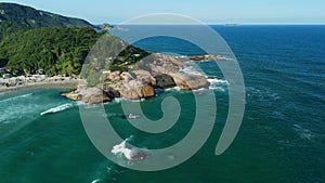 Popular beach with rocks and ocean in Floripa, Brazil. Aerial view
