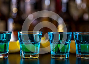 Popular blue drink shot kamikaze on the background of the bar wi