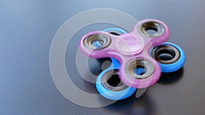 Popular colourful fidget spinner toy on a black background