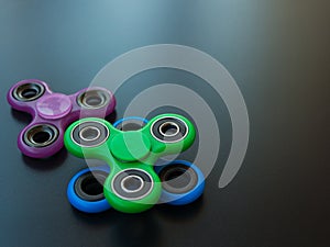 Popular colourful fidget spinner toy on a black background