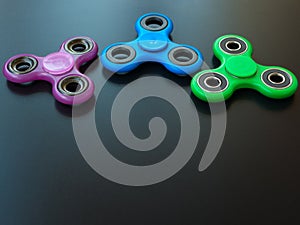 Popular colourful fidget spinner toy on a black background