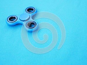 Popular colourful fidget spinner toy on a colored background