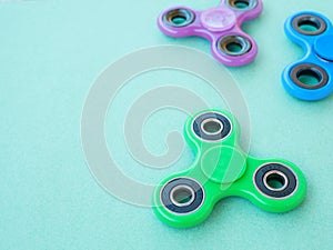 Popular colourful fidget spinner toy on a colored background