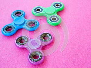 Popular colourful fidget spinner toy on a colored background