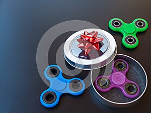 Popular colourful fidget spinner toy in a gift box on a black background