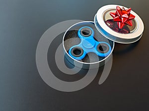 Popular colourful fidget spinner toy in a gift box on a black background