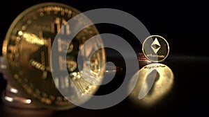 Popular cruptocurrency on the table. Bitcoin and Etherium wwith nice gold reflection on the surface. Cocus shifts from