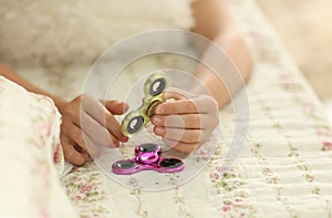Popular fidget spinner toy - closeup focused on spinner, home interior