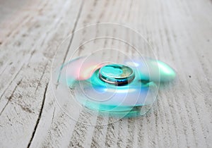 Popular fidget spinner toy on white wood background