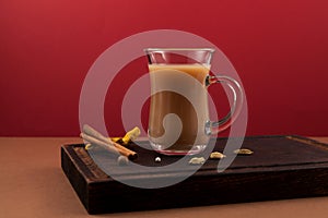 Popular Indian drink Karak tea or Masala chai. Prepared with the addition of milk, variety of spices and spices. Transparent cup