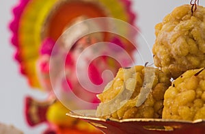 Popular Indian sweet dish known as Boondi laddu served in golden platter. photo