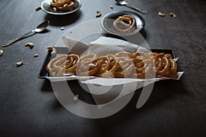 Popular Indian sweet jalebi or imarati made by deep frying in pure ghee served in a tray.