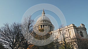 Popular London tourist attraction and landmark of St Pauls Cathedral on a bright blue sky day with A