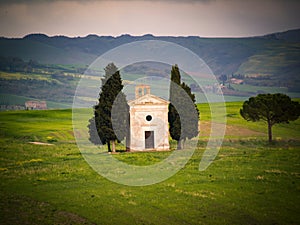 Popular photography and touristic location in Tuscany, amazing Vitaleta chapel at colorful sunset,  Tuscany, Italy