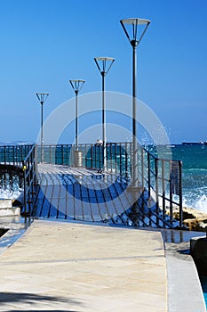 A popular place for walking along the Limassol seafront Molos Beach on a bright sunny day photo