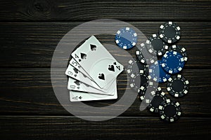 A popular poker game with a winning combination of high card. Cards with chips on a black vintage table in a poker club