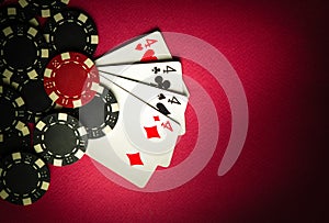 A popular poker game with a winning hand of four of four of a kind or quads. Cards and chips from winning on a red table in a