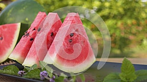 Popular summer refreshment. Hands taking watermelon slices from a plate