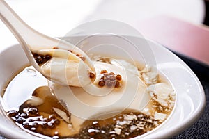 Popular Taiwan gourmet - Dessert of tapioca pearl ball bubble mixed bean curd tofu pudding douhua, dou hua in white bowl,