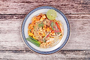 Popular Thai fried noodle call Pad Tai on Thai-pattern dish.