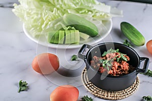 Popular Thai Northern Food style meat and tomato relish spicy dip sauce, usually eat with fresh vegetables call nam phrik aawng ,