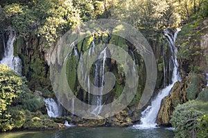 Popular with tourists Kravica waterfall is a large tufa cascade on the TrebiÅ¾at River, in the karstic heartland of Herzegovina in