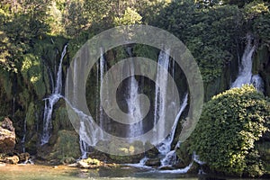 Popular with tourists Kravica waterfall is a large tufa cascade on the TrebiÅ¾at River, in the karstic heartland of Herzegovina in