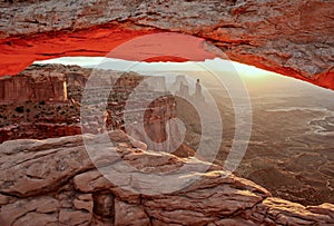 Popular view of Canyonlands national park in Utah through Mesa Arch into deep canyon