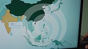 Population by country on world map on laptop screen. Population in India and China, most populated countries.