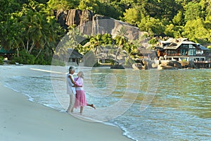 Porait of elderly couple resting on beach