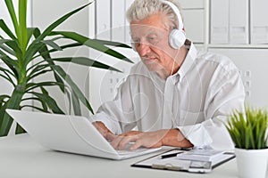 Porait of senior man using laptop at home