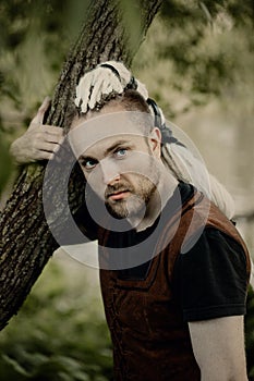 A porait of a young man with interesting depicts a viking looks to the camera photo
