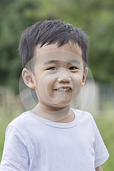 Poratriat head shot of toothy smiling face of asian 1 year old c