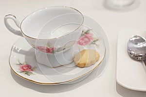 Porcelain antique tea cup with a cookie for afternoon tea