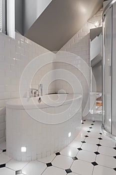 Porcelain bathtub in white washroom