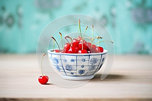 porcelain bowl filled with red cherries