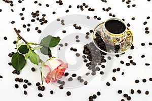 Porcelain coffee cup with rose flower and coffee beans