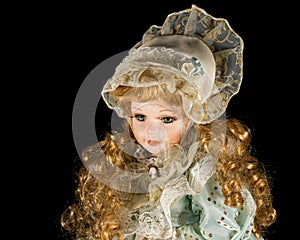 Porcelain doll, isolated on black background