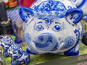 Porcelain figurines of a pig and two piglets made in the Russian style Gzhel