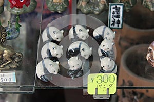 Porcelain figurines representing pandas are sold in a store (Japan)