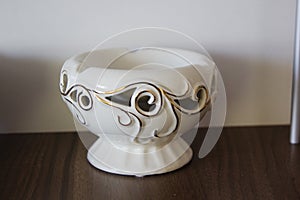 The porcelain inlaid bowl stands on a brown background (patterned