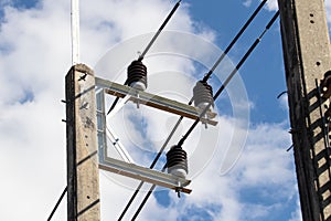 Porcelain insulator in nature day light and this is post type insulators. Bright blue sky bright sunlight in background.