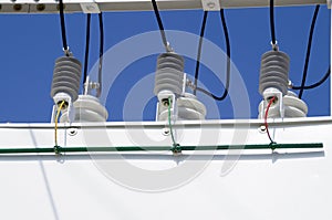 Porcelain insulators of high-voltage substation on blue sky