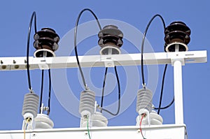 Porcelain insulators of high-voltage substation on blue sky