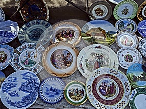 Porcelain plates with beautiful pictures at the flea market