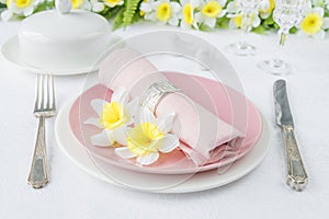 Porcelain plates, silverware and spring flowers